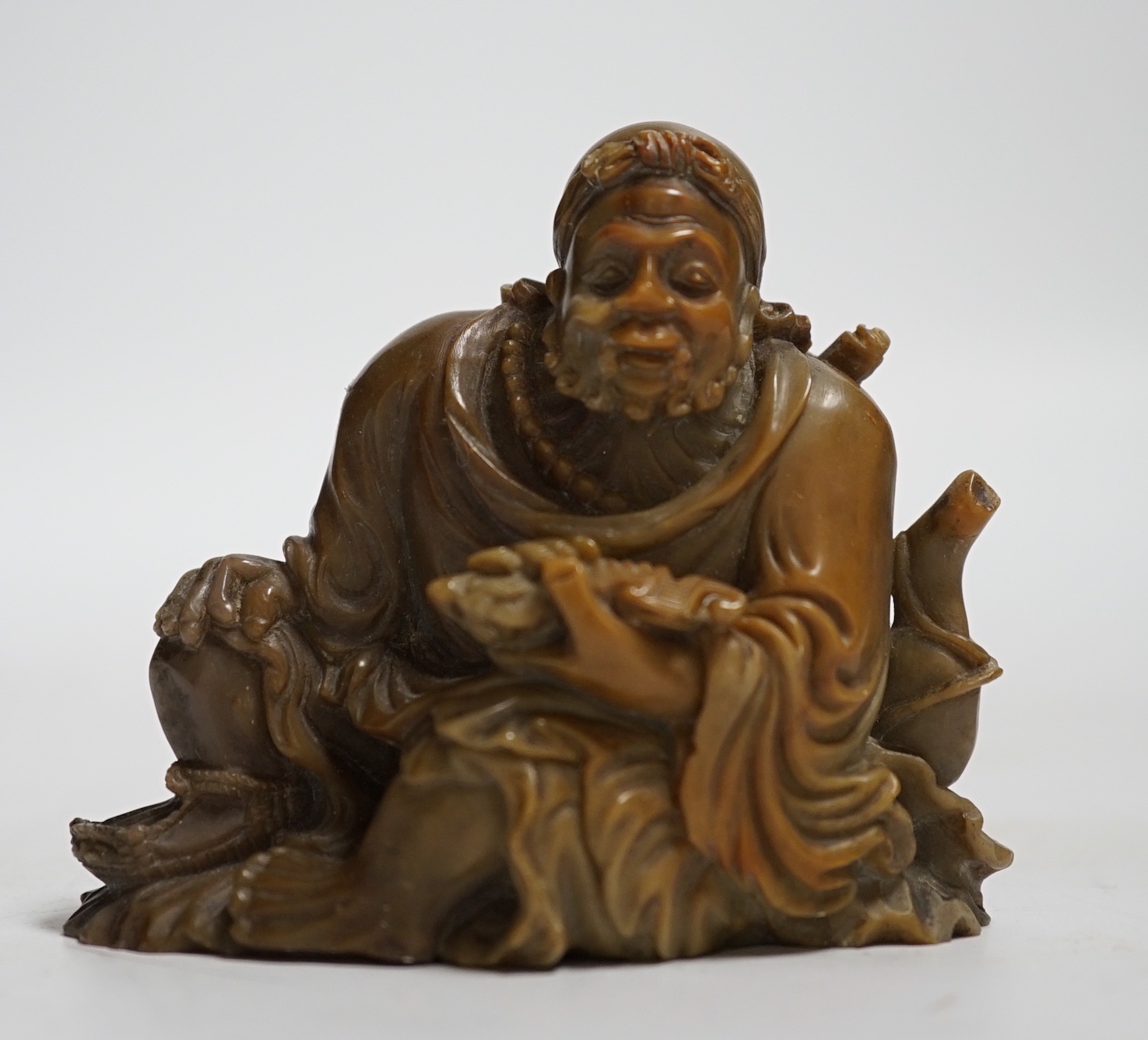 A Chinese soapstone carving of a sage, 7cm wide